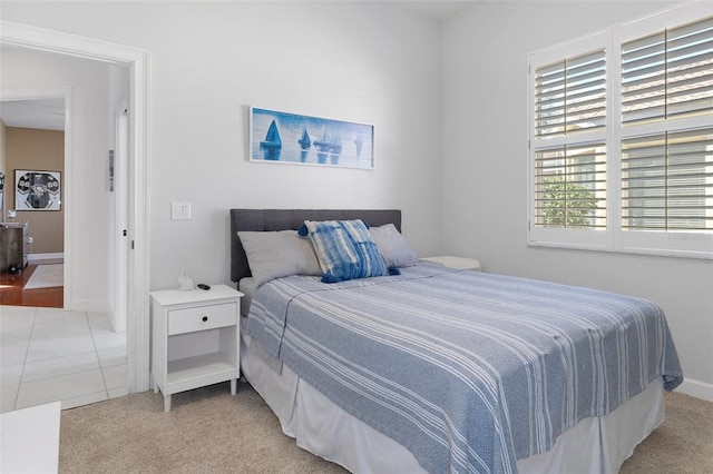 bedroom featuring light carpet