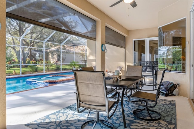 sunroom featuring ceiling fan and a pool