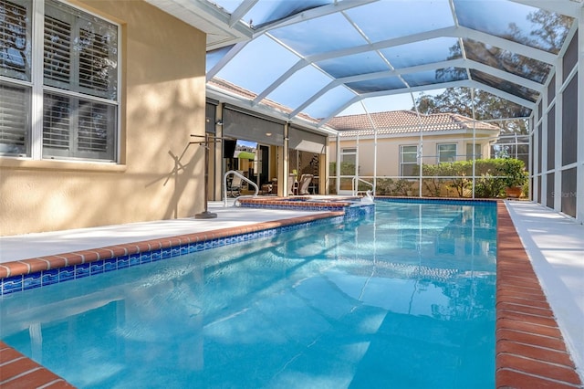 view of swimming pool featuring a lanai and a patio area