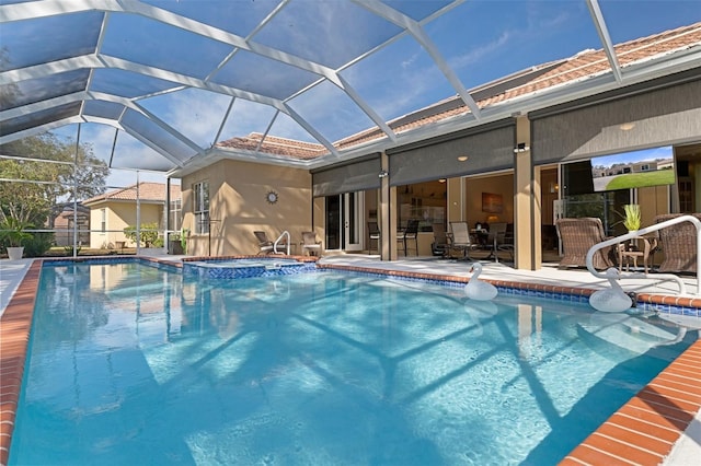 view of swimming pool with an in ground hot tub, a patio, and glass enclosure