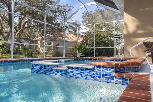 view of swimming pool with an in ground hot tub and a lanai