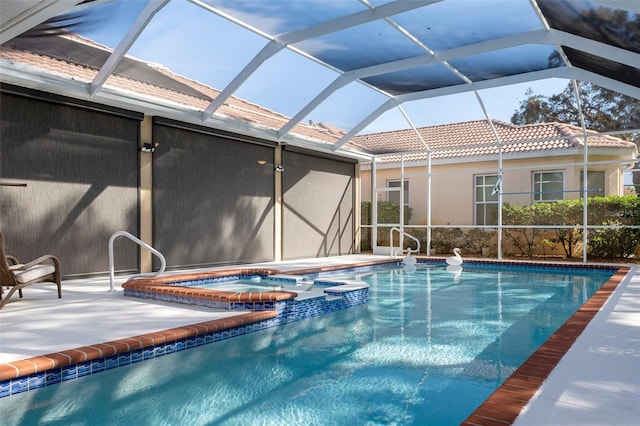 view of swimming pool with glass enclosure, an in ground hot tub, and a patio