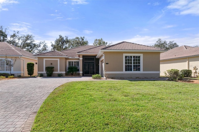 mediterranean / spanish-style home with a front yard