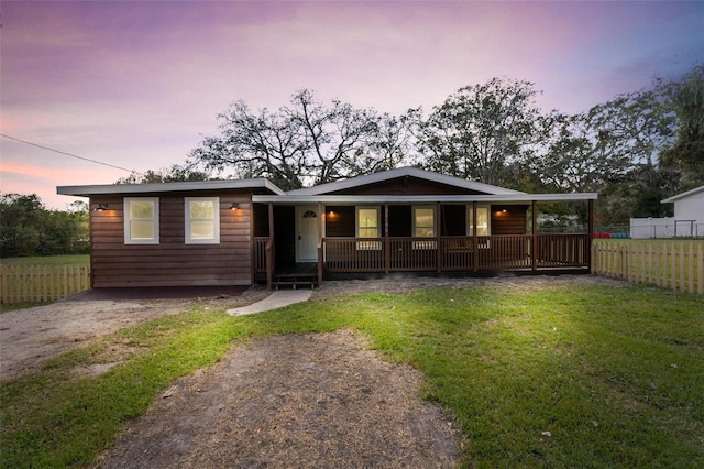 view of front of property with a yard and covered porch