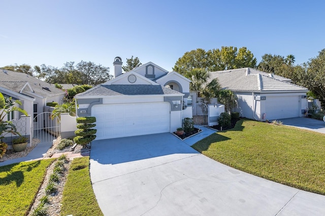 ranch-style home featuring a garage and a front lawn