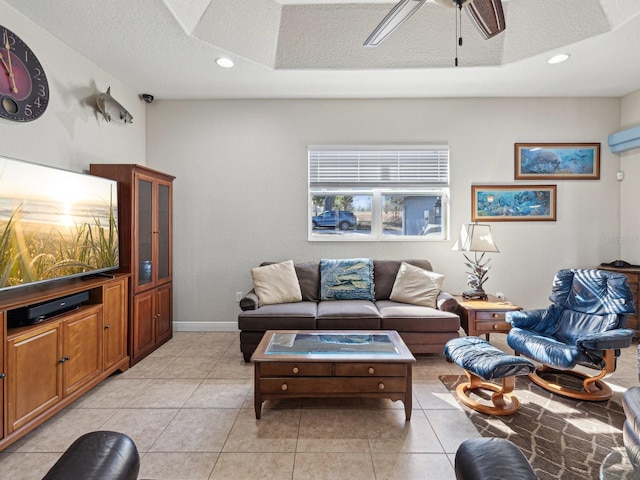 living room featuring ceiling fan, a wall mounted AC, a textured ceiling, and light tile patterned flooring