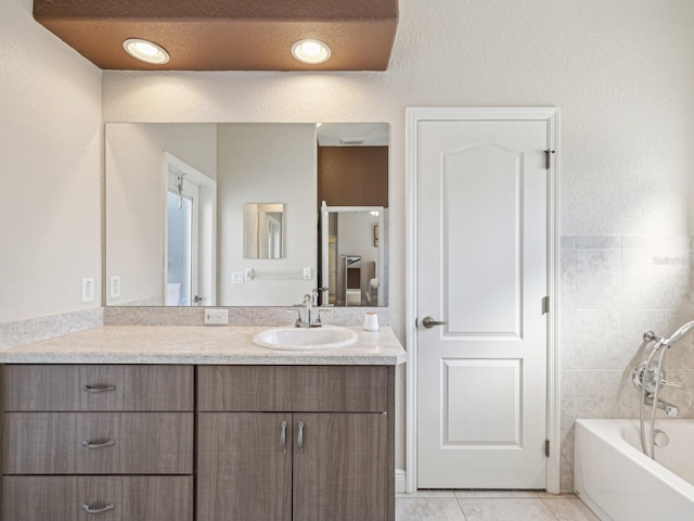 bathroom featuring tile patterned floors, vanity, and shower / washtub combination