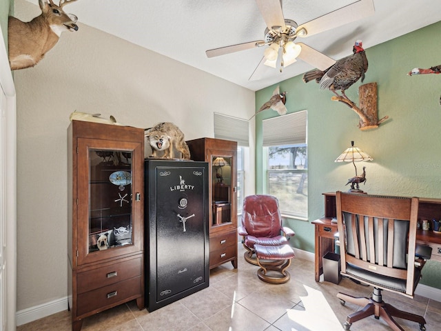 office space with light tile patterned floors and ceiling fan