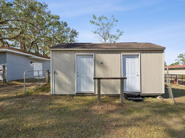 view of outdoor structure featuring a lawn