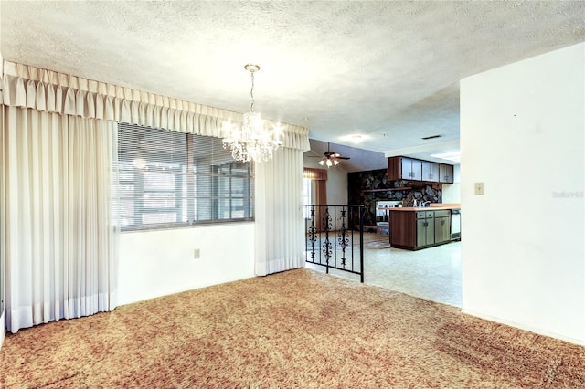 carpeted dining room featuring ceiling fan with notable chandelier and a textured ceiling