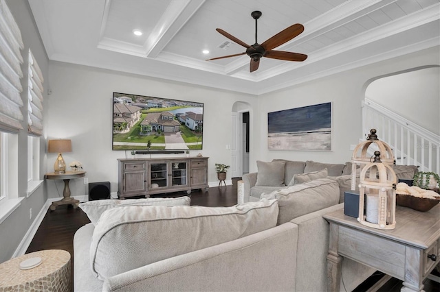 living room with ornamental molding, ceiling fan, dark wood-type flooring, and beam ceiling