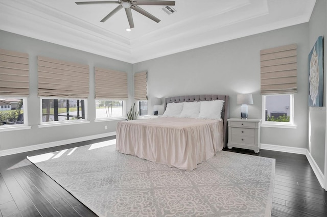 bedroom with a raised ceiling, ceiling fan, dark hardwood / wood-style floors, and ornamental molding