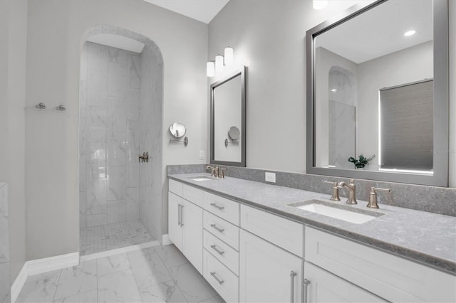 bathroom with vanity and tiled shower