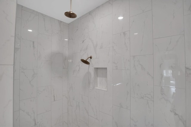 interior details with a tile shower