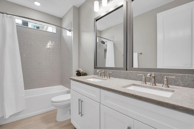 full bathroom with shower / bath combination with curtain, vanity, toilet, and wood-type flooring