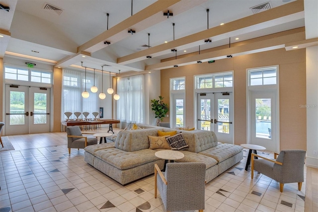 living room featuring french doors, a towering ceiling, light tile patterned floors, and a healthy amount of sunlight