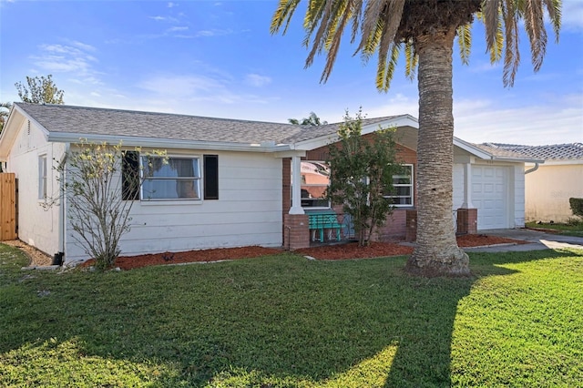 ranch-style home with a front lawn and a garage