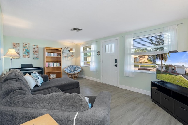 living room with hardwood / wood-style flooring and a healthy amount of sunlight