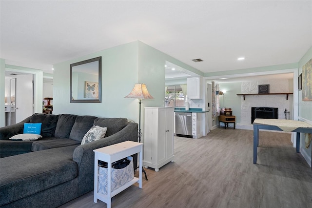 living room featuring light hardwood / wood-style floors and a fireplace