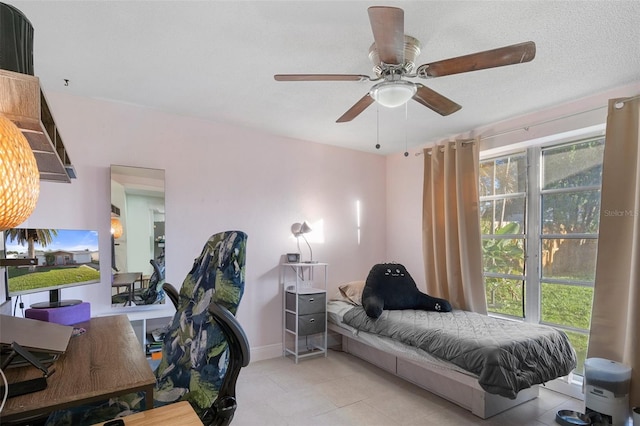 bedroom with ceiling fan, light tile patterned floors, and multiple windows