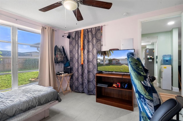 bedroom with stainless steel refrigerator and ceiling fan