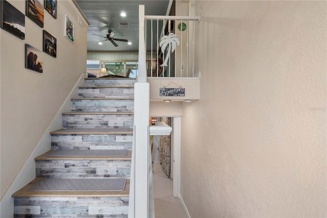 stairway with hardwood / wood-style flooring and ceiling fan