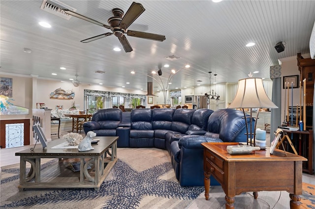 living room with ceiling fan and ornamental molding