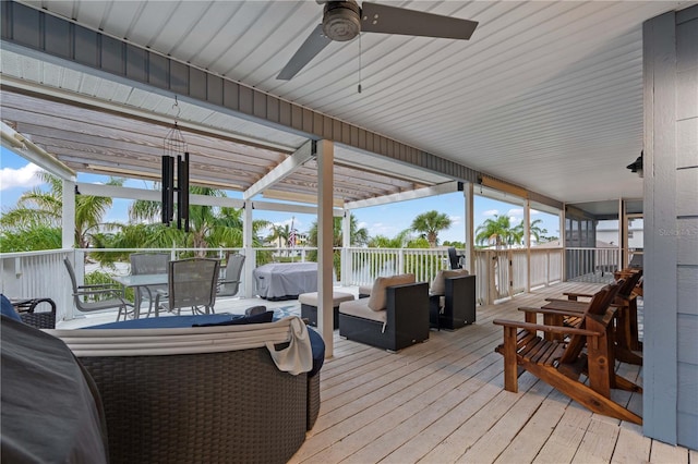 wooden terrace featuring ceiling fan and an outdoor living space