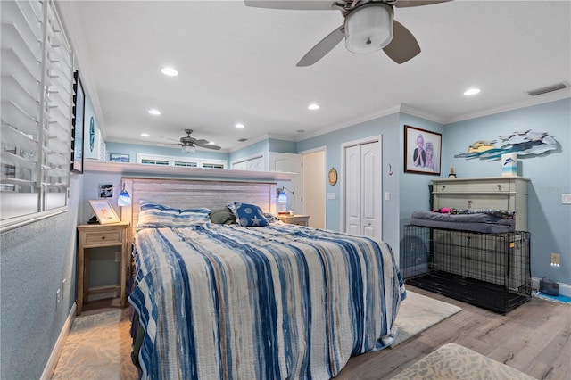 bedroom featuring ceiling fan, light hardwood / wood-style flooring, and ornamental molding