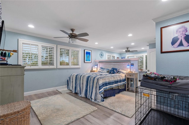 bedroom with hardwood / wood-style floors, ceiling fan, and ornamental molding