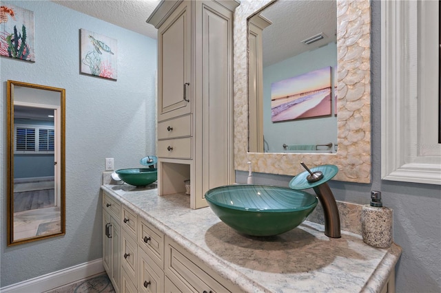 bathroom featuring vanity and a textured ceiling