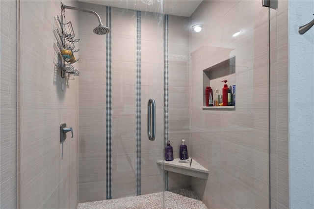 bathroom with a shower with door