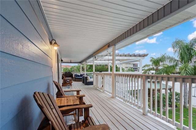 deck with an outdoor hangout area and a pergola