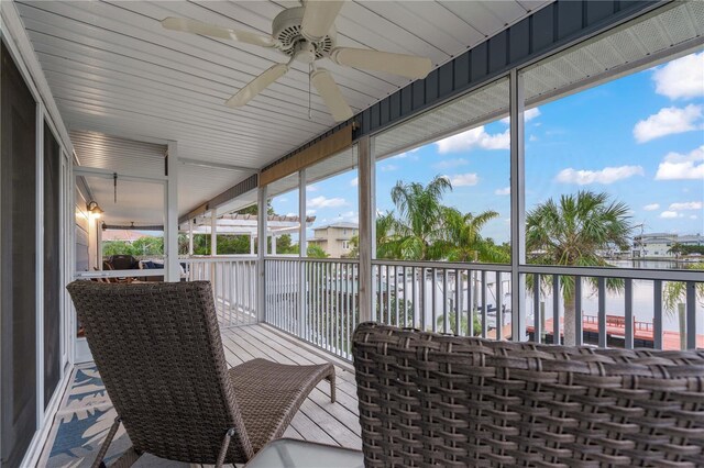 sunroom featuring a healthy amount of sunlight and a water view