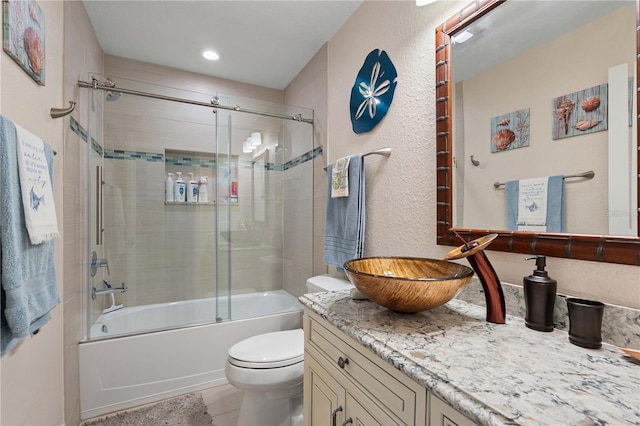 full bathroom with shower / bath combination with glass door, vanity, and toilet