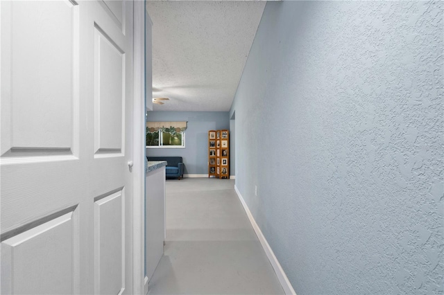 corridor featuring a textured ceiling