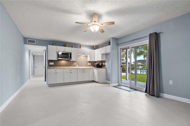 kitchen with tasteful backsplash, white cabinetry, ceiling fan, and a textured ceiling