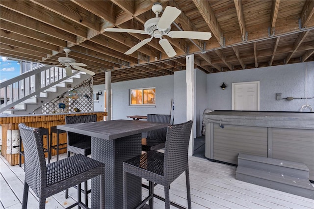 wooden deck featuring a hot tub