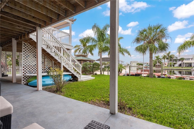 view of yard with a patio and a water view