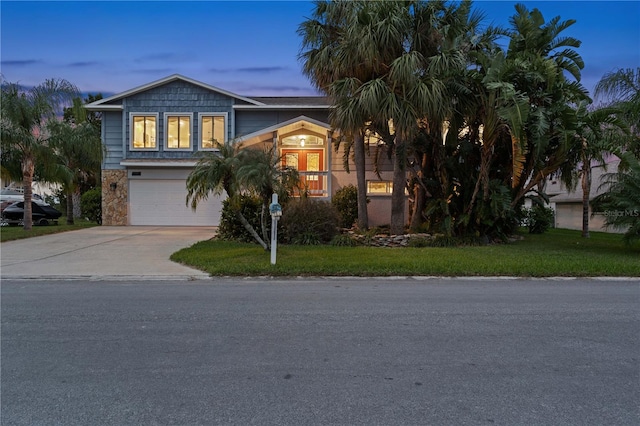 view of front of house with a yard and a garage