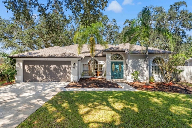 view of front of property with a garage and a front lawn