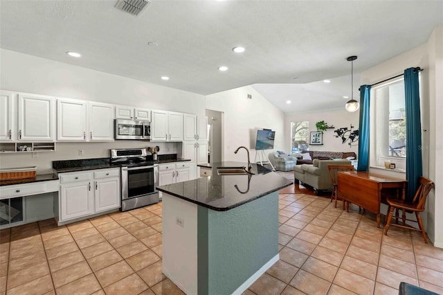 kitchen featuring appliances with stainless steel finishes, sink, light tile patterned floors, white cabinetry, and hanging light fixtures