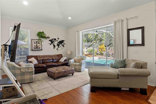 living room with hardwood / wood-style flooring and ornamental molding