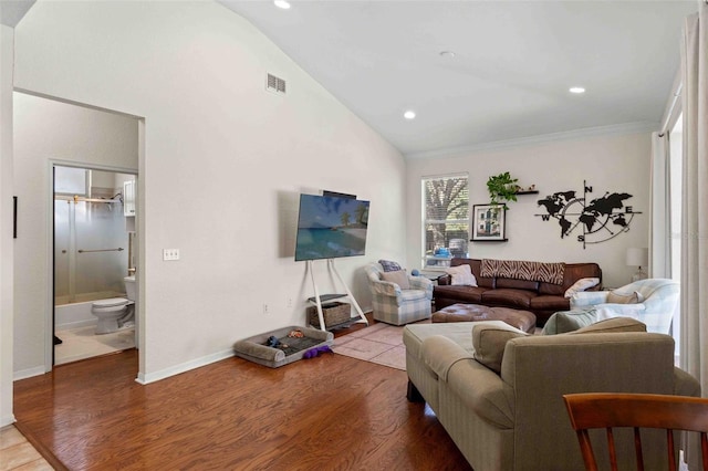 living room featuring crown molding, hardwood / wood-style floors, and vaulted ceiling