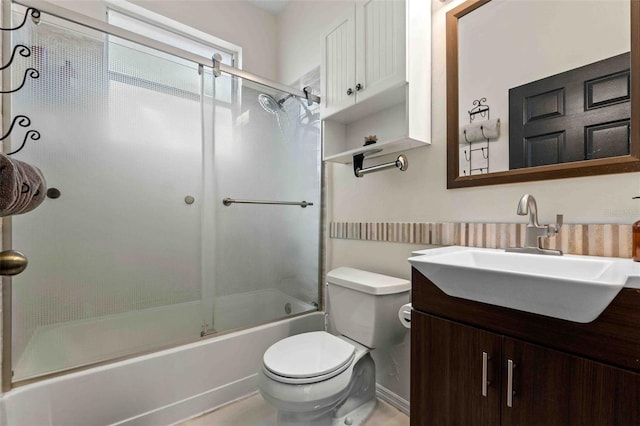 full bathroom featuring shower / bath combination with glass door, vanity, and toilet