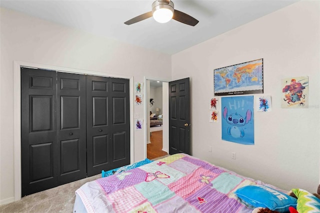 carpeted bedroom featuring a closet and ceiling fan