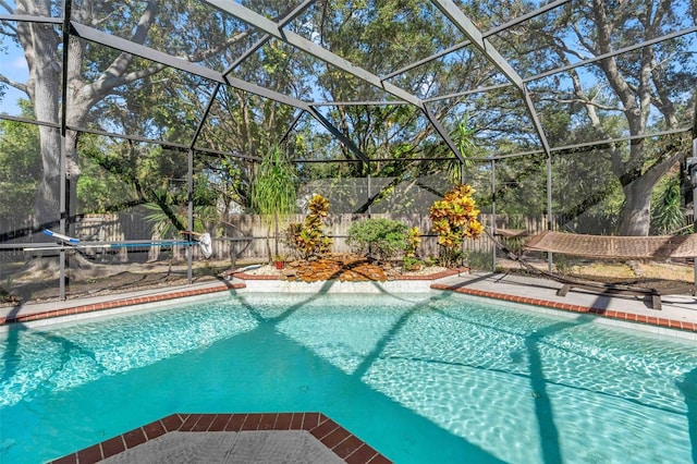 view of pool with glass enclosure