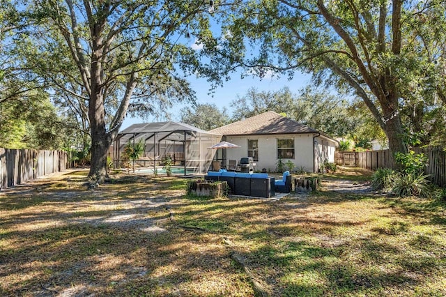 view of yard with glass enclosure, a fenced in pool, and an outdoor living space