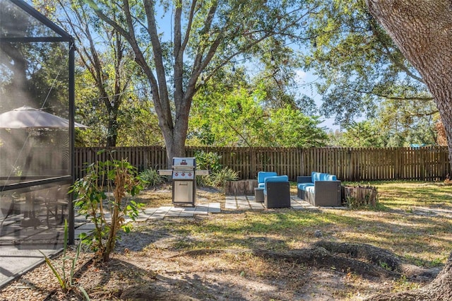 view of yard with an outdoor living space, a lanai, and a patio