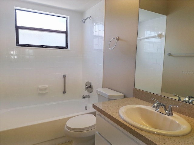 full bathroom with vanity, toilet, and tiled shower / bath